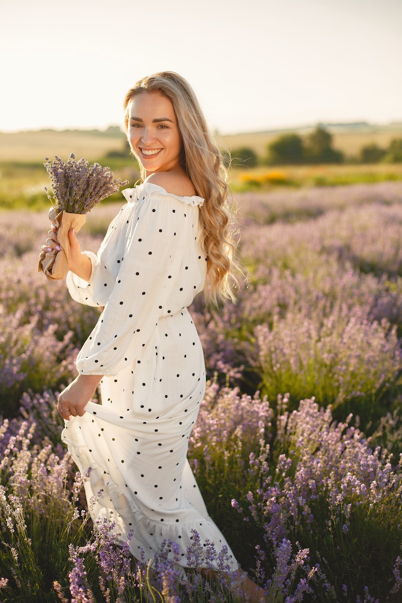 A Woman in a Polka Dot Dress Holding Flowers