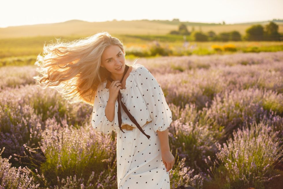 A Woman in a Polka Dot Dress Standing in a Lavender Field